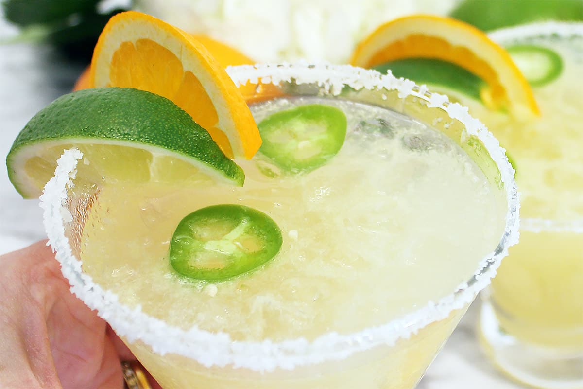 Closeup of salted rim with orange and lime garnish.
