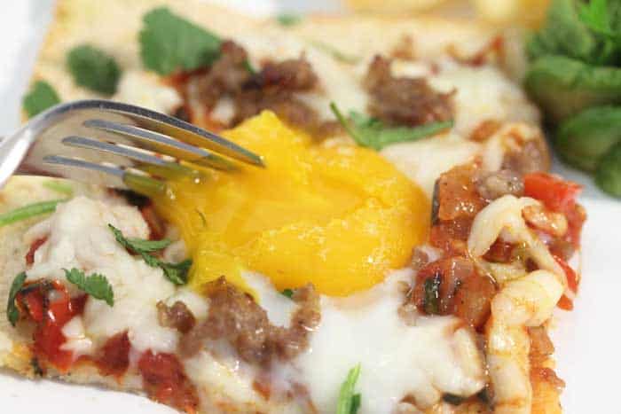 Shakshuka Breakfast Pizza breaking the yolk