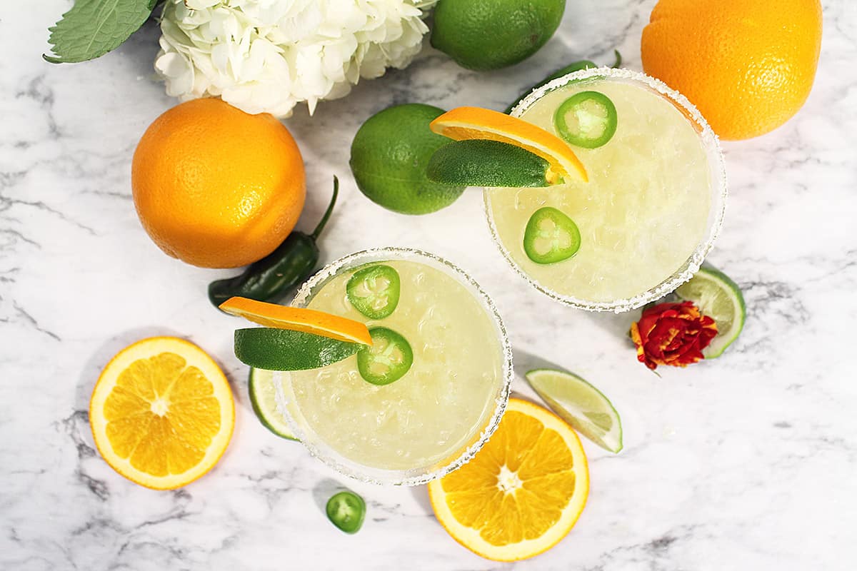 Overhead or two Texas Margaritas with fruit around them.