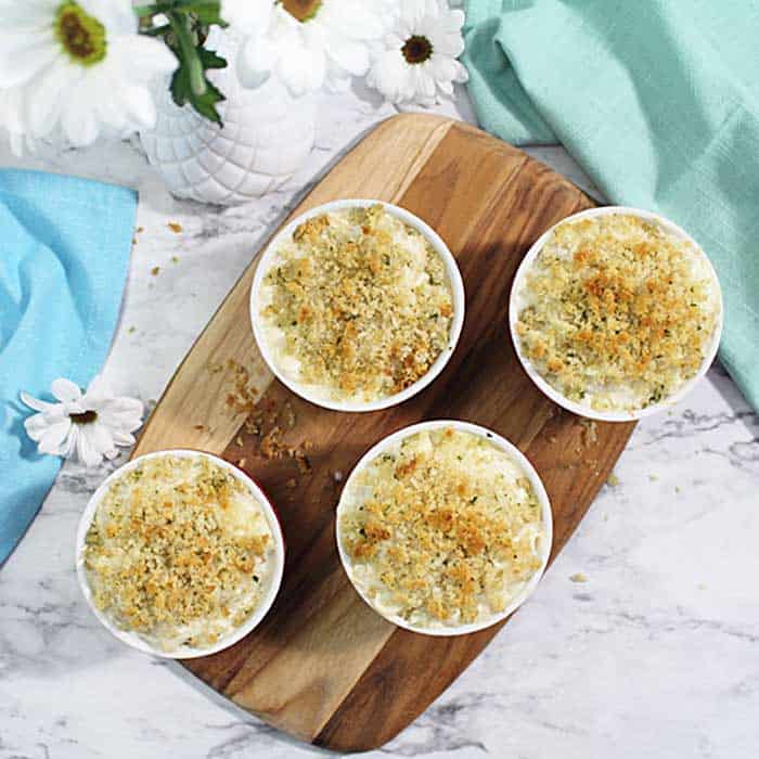 Baked Mac and Cheese in ramekins on wooden board square