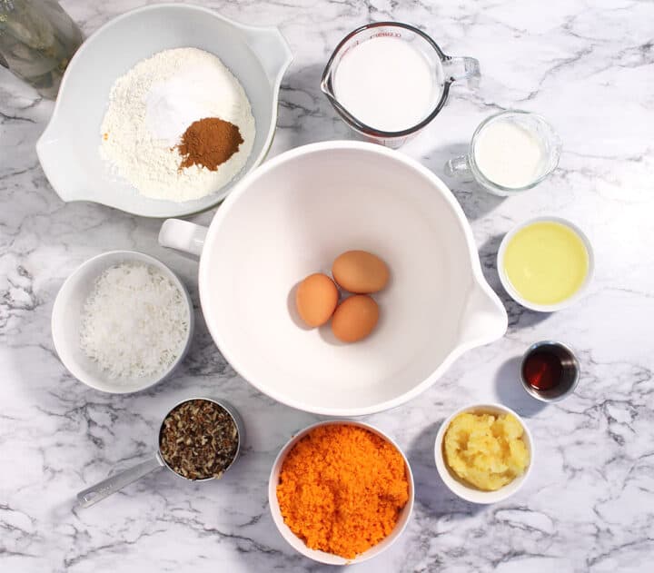 Carrot Sheet Cake ingredients on marble surface.