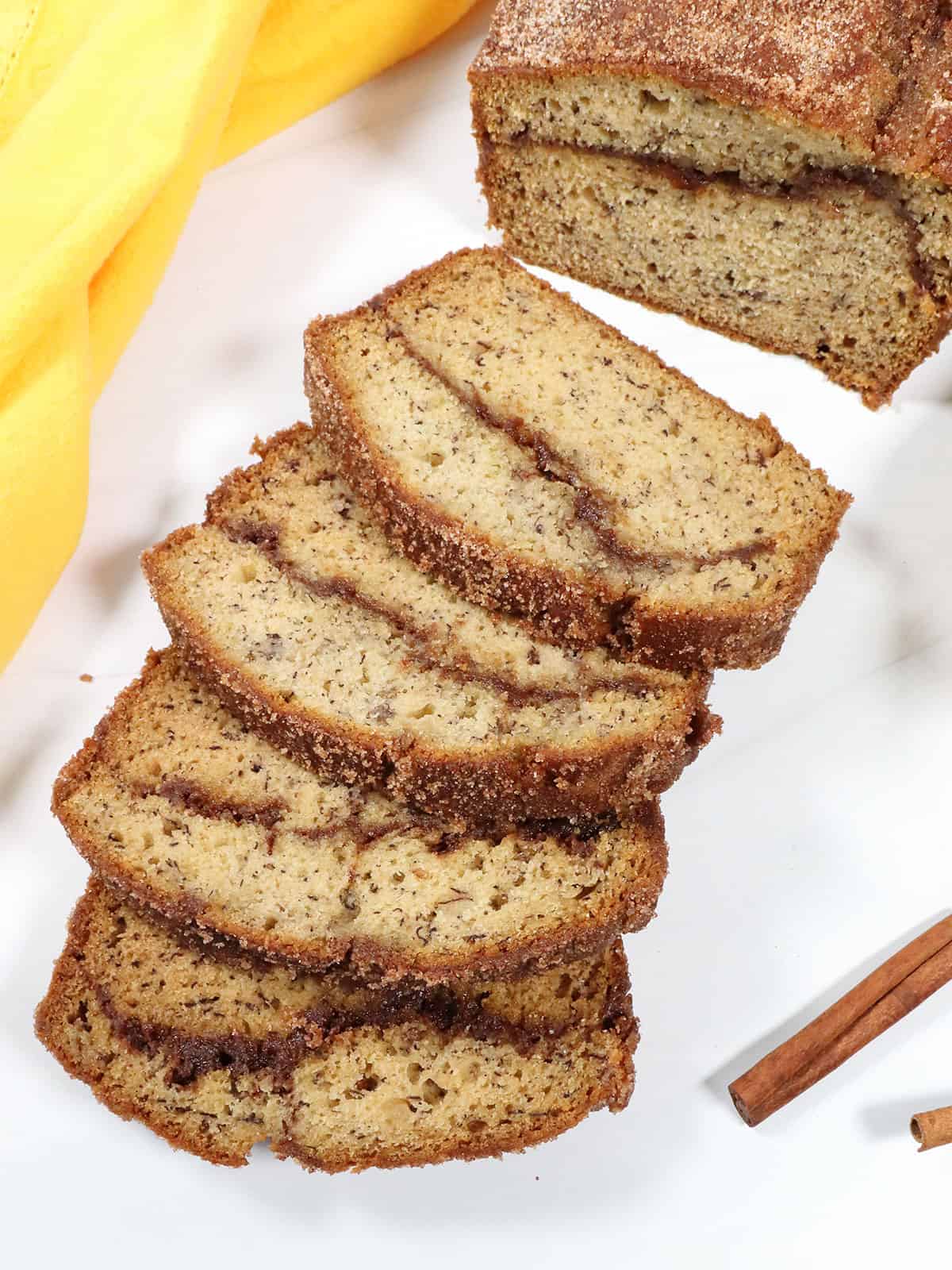 Sliced banana bread showing cinnamon crumb swirl.