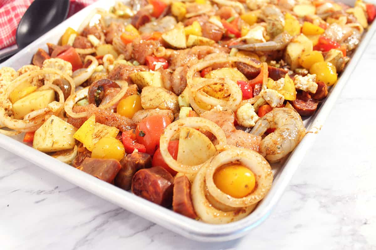Closeup of sheet pan and ingredients ready for oven.