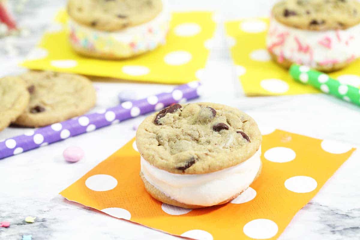 placing cookie on top of ice cream to make sandwich.