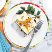 Overhead of single slice on plate on top of spring colored napkins.