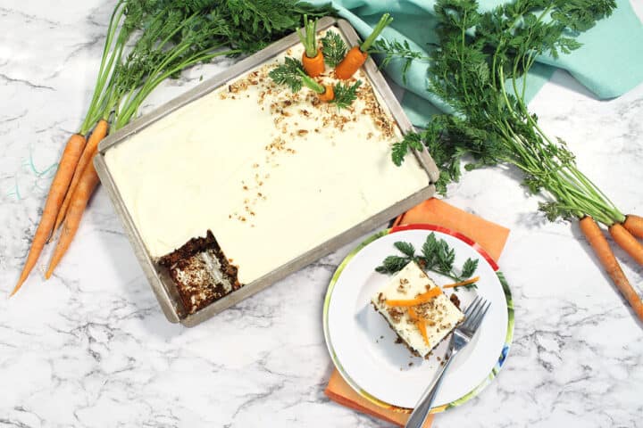 Overhead of whole carrot cake with slice next to it.