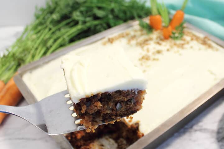 Serving of cake on spatula over whole cake.