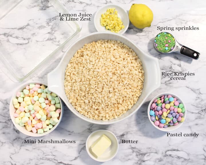 Ingredients for Easter Rice Krispie Treats on white marble.