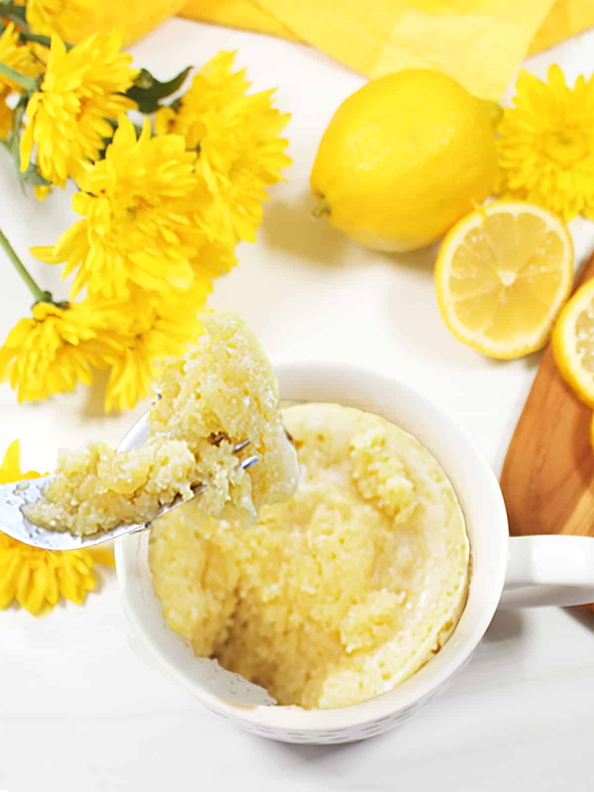 Microwave lemon Mug Cake with bite on fork.