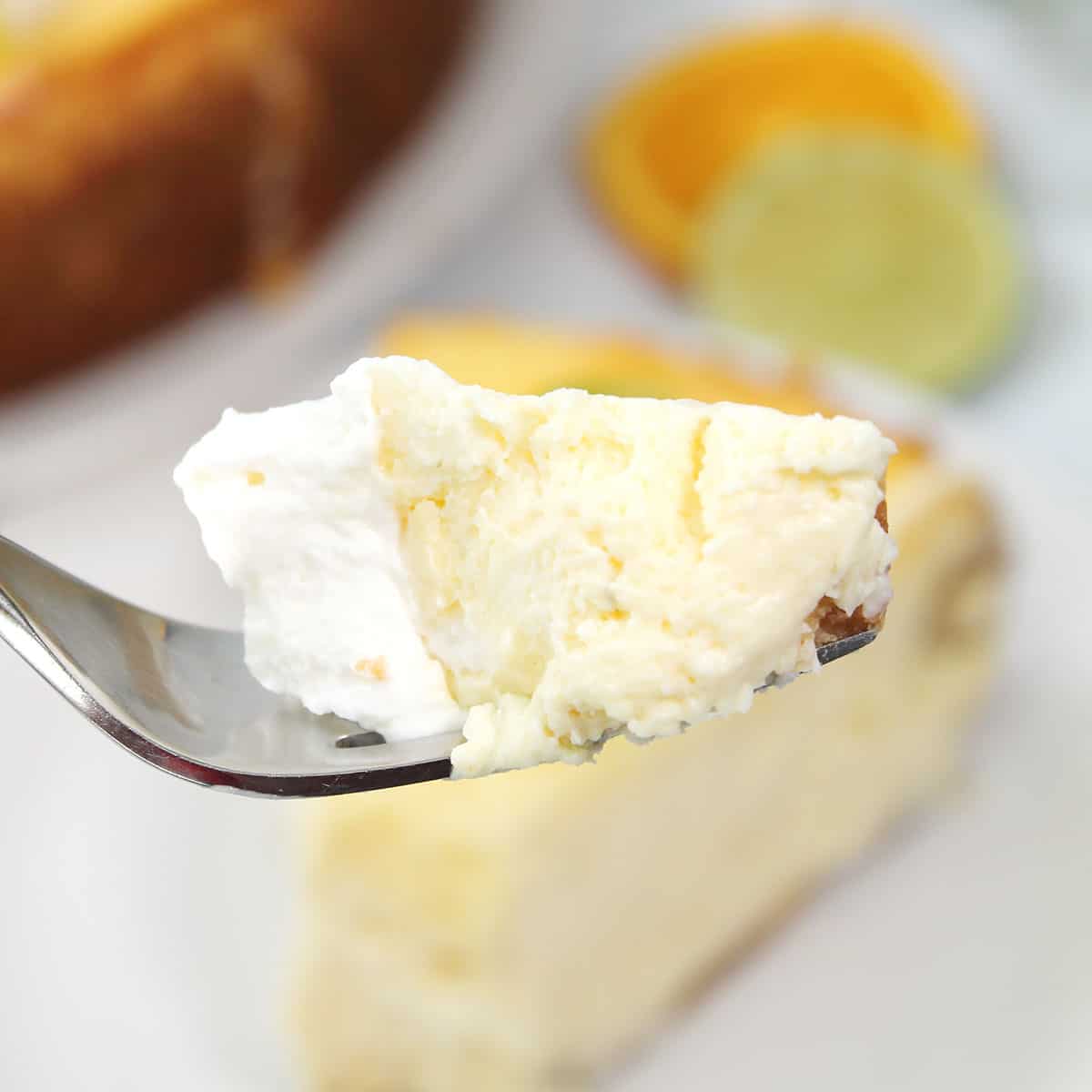 Bite of cheesecake on fork.
