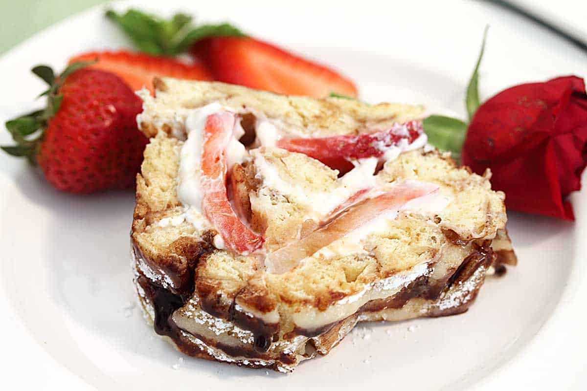 Closeup of slice on plate with strawberries.