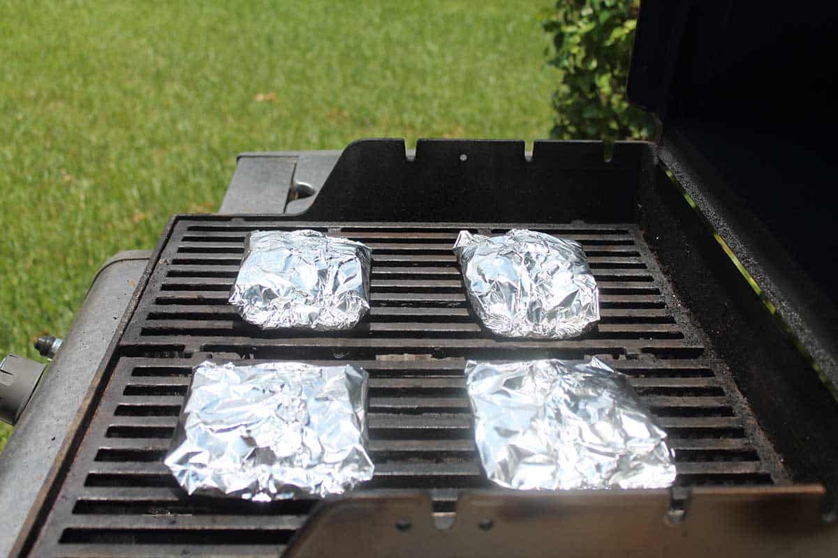 Shrimp foil packets on grill.