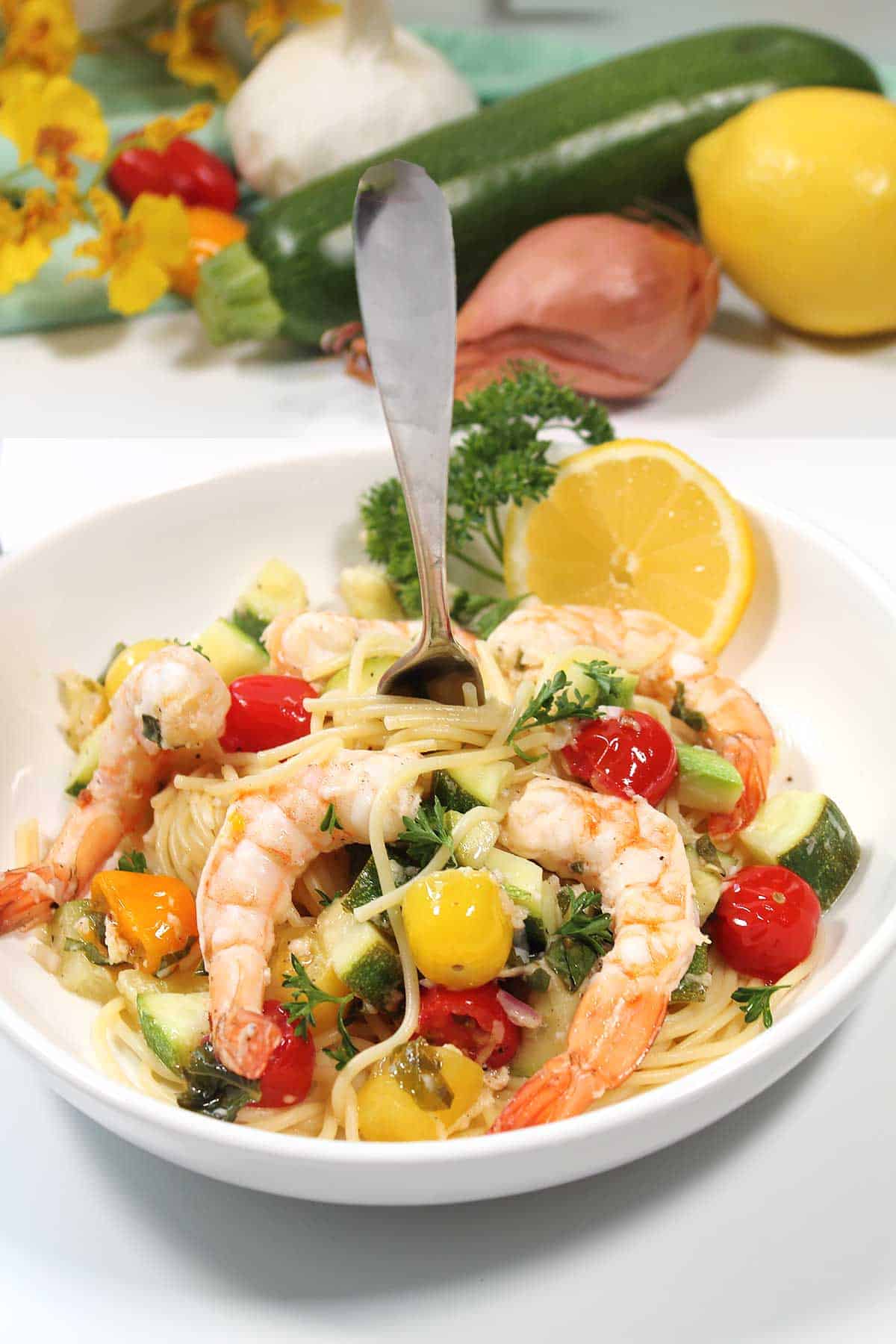 Grilled shrimp and vegetables over pasta.