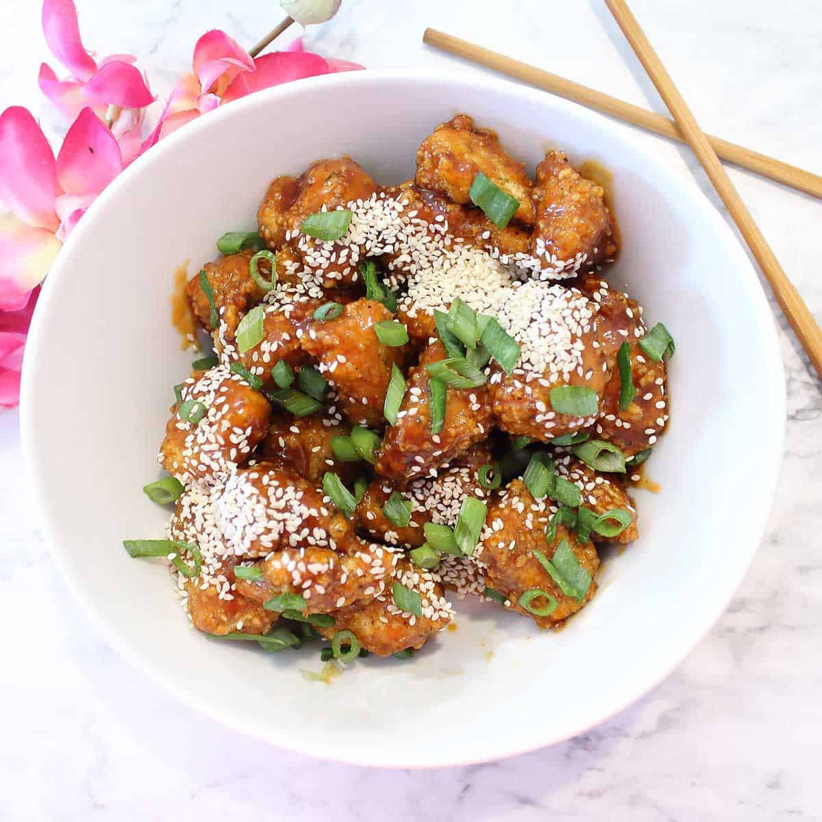 Overhead of garnished honey garlic chicken dish.