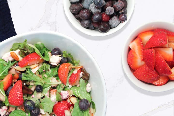 Overhead of Strawberry Blueberry Salad with berries beside it.
