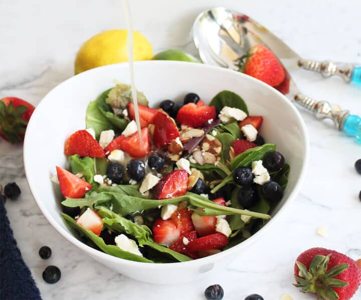 Pouring dressing over salad.