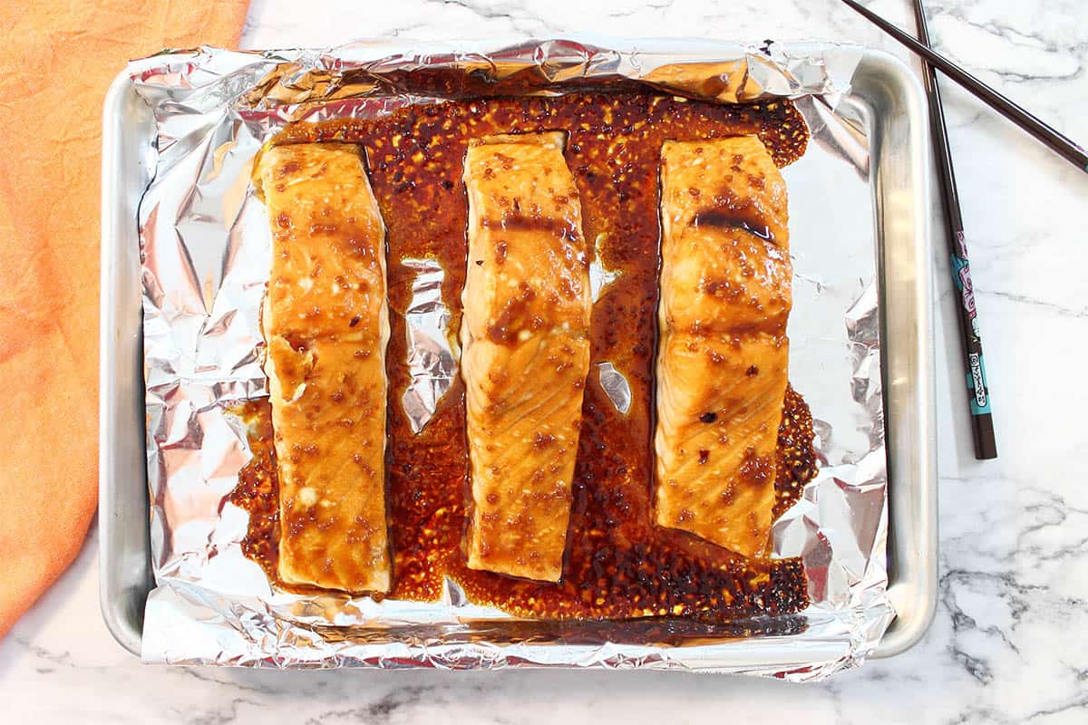 Baked salmon with nice glaze on foil lined cookie sheet.
