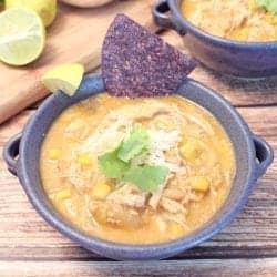 Single bowl of chicken chili with corn chip garnish.
