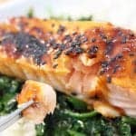 Closeup of bite of salmon on fork.