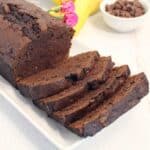 Closeup of sliced banana bread with chocolate chips on platter.