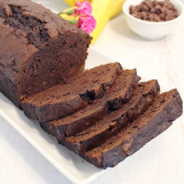 Closeup of sliced banana bread with chocolate chips on platter.