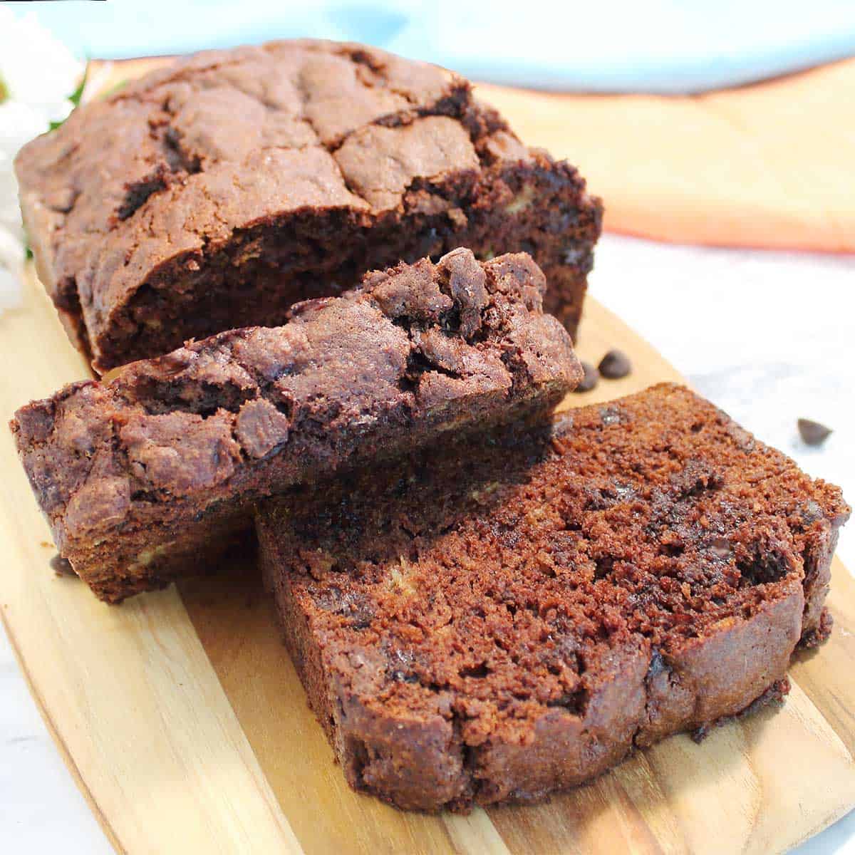 Thick sliced chocolate chip banana bread on cutting board.