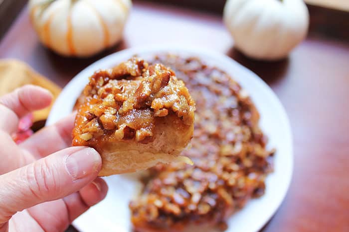 Picking up a pecan sticky bun for a closeup shot.