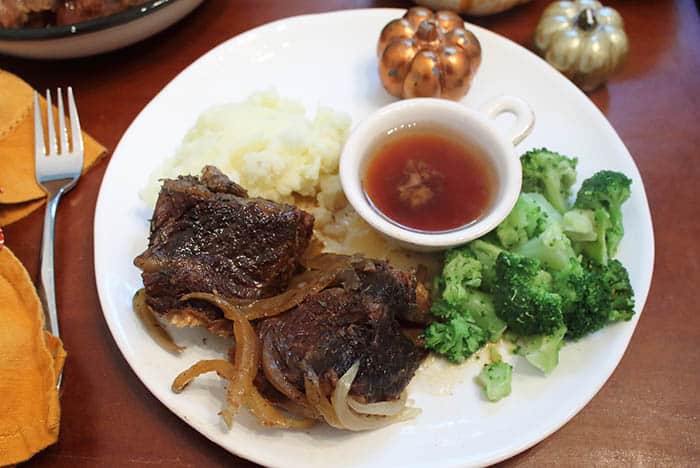 Crockpot Short Ribs dinner with sides of mashed potatoes and broccoli.