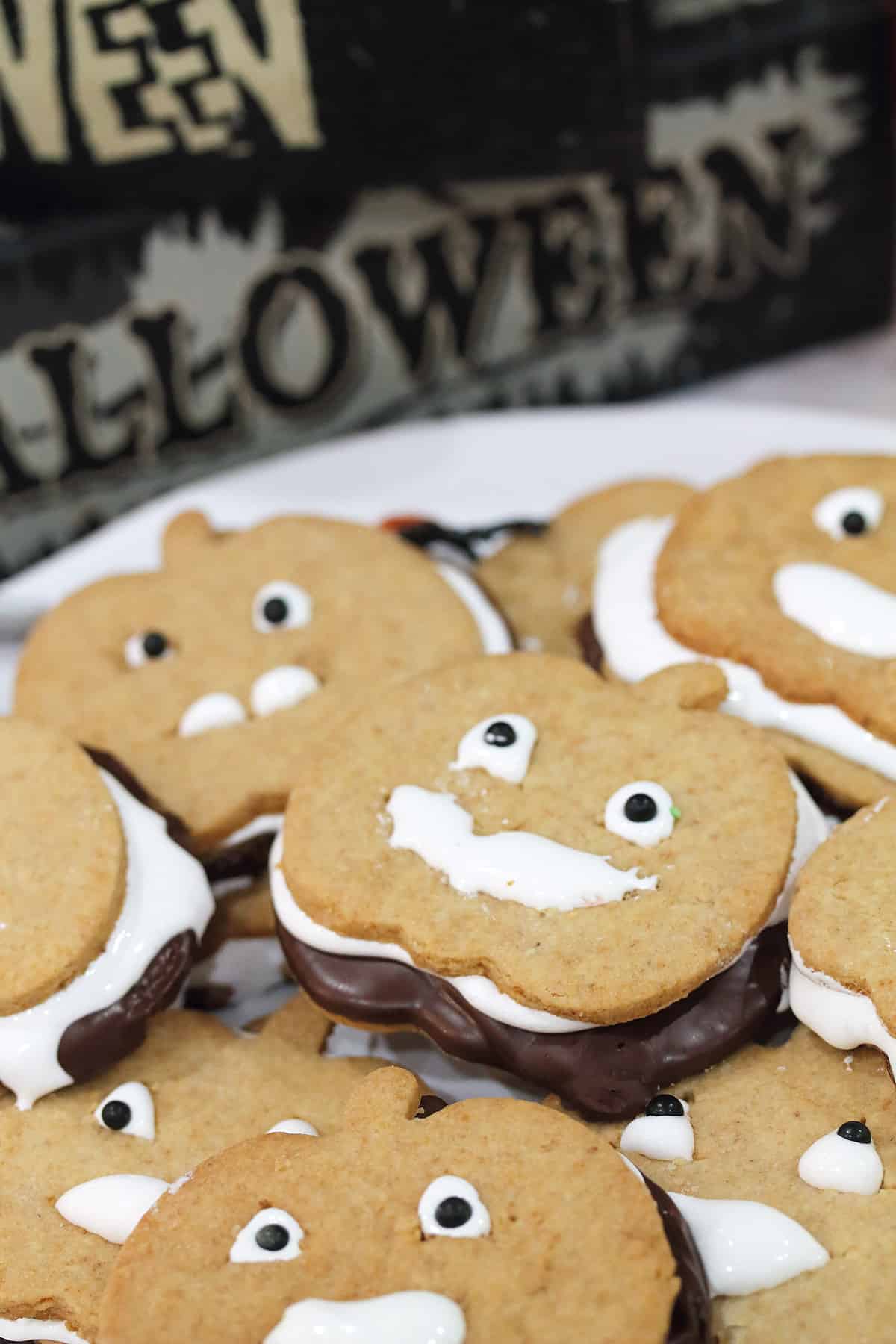 Stacks of easy s'mores cookies on white plate.