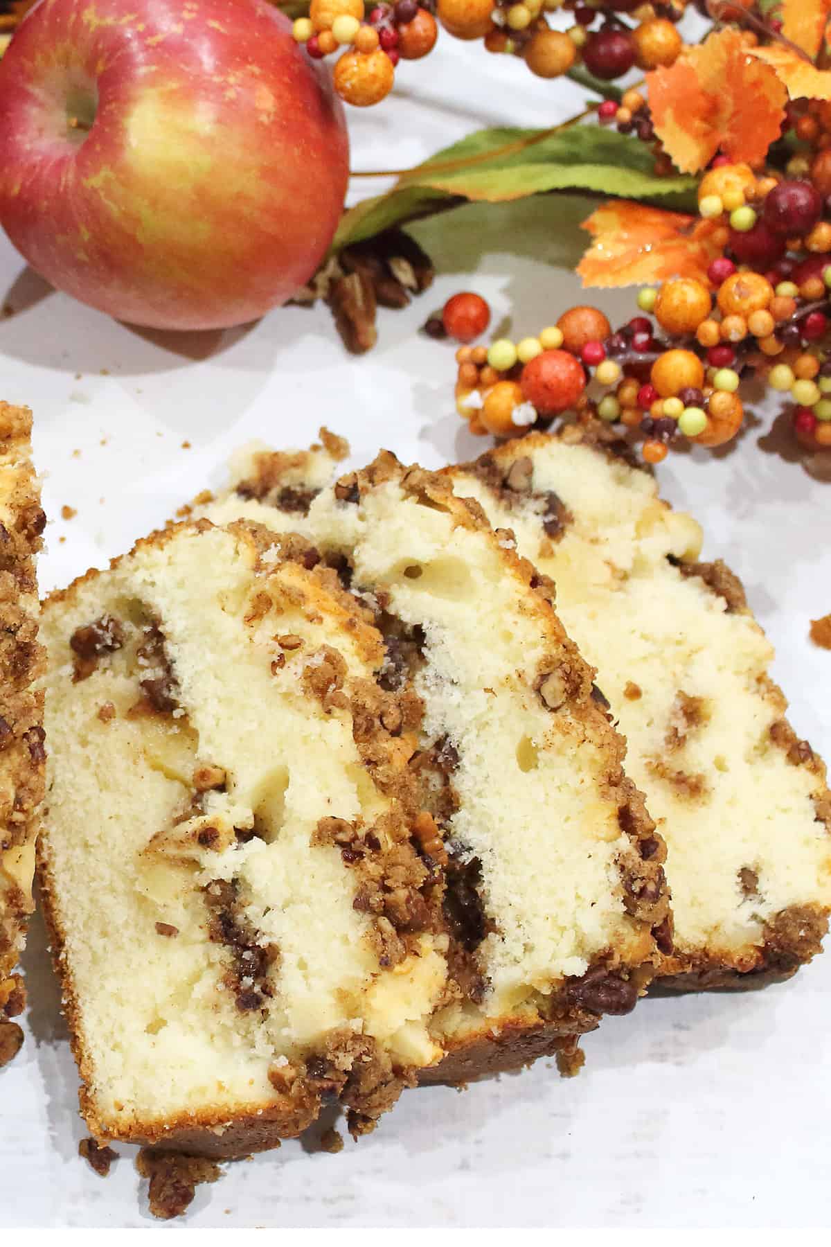 Overhead of sliced bread showing streusel on white table.