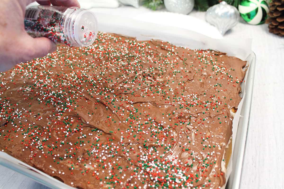 Sprinkle colorful sprinkles on top of chocolate-marshmallow mixture..
