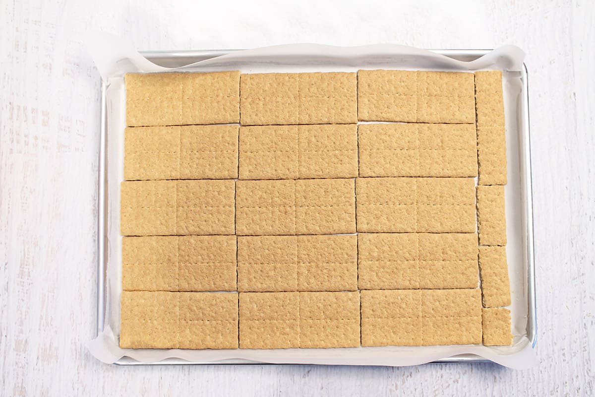 Graham crackers on a parchment lined baking sheet.