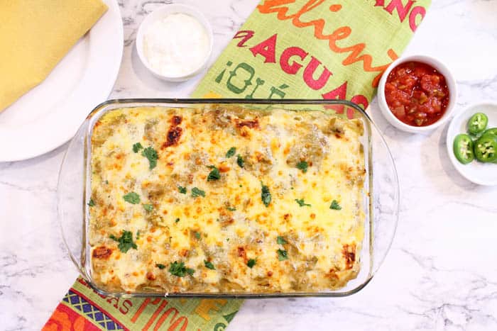 Baked casserole right out of the oven on green mexican towel.
