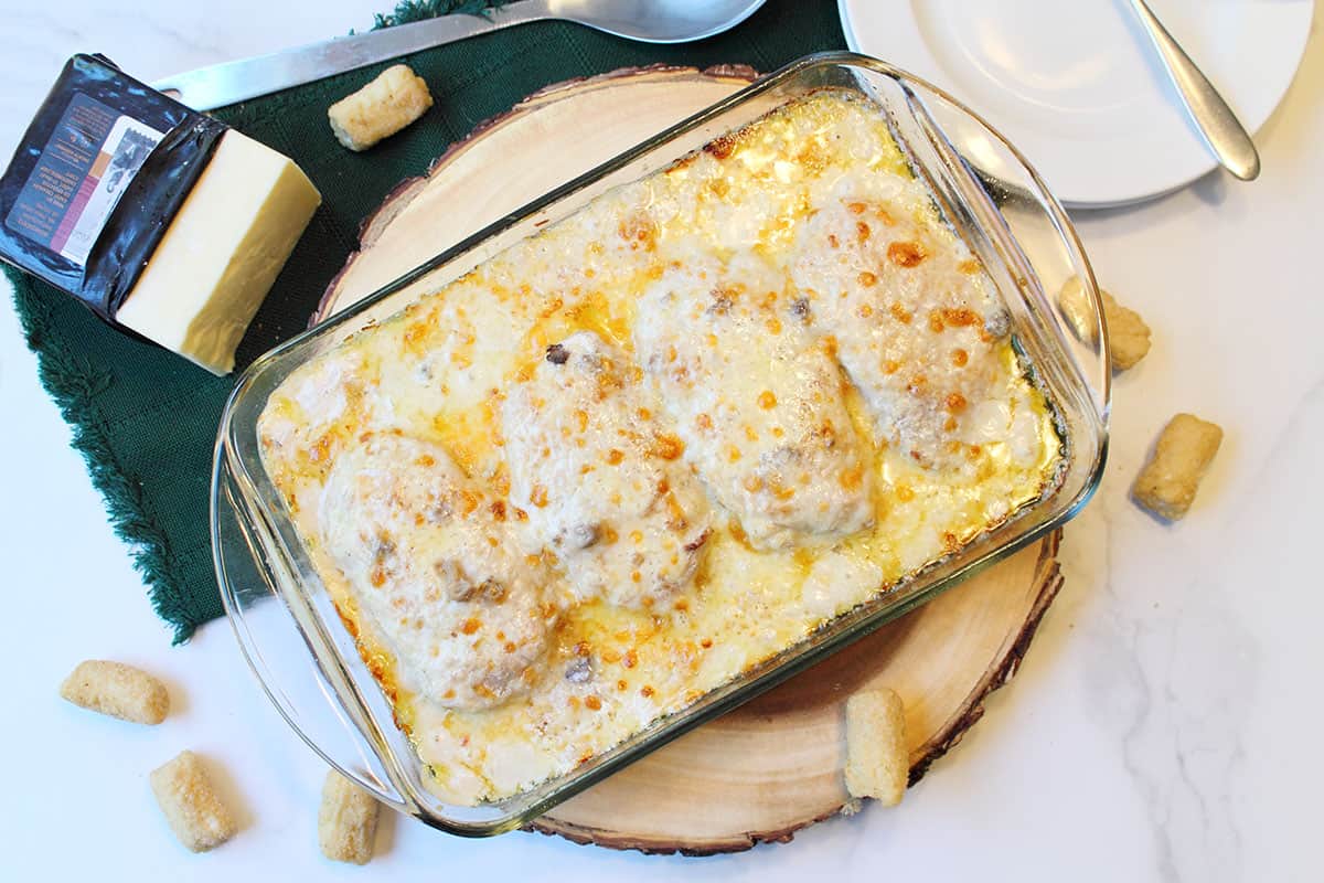 Dump and Bake Casserole Browned and ready to serve shown on top of wooden block.