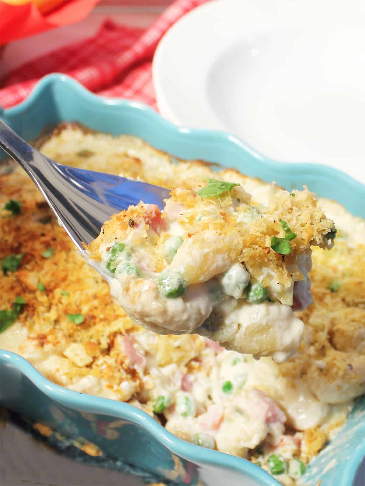 A serving spoonful of Gnocchi casserole.