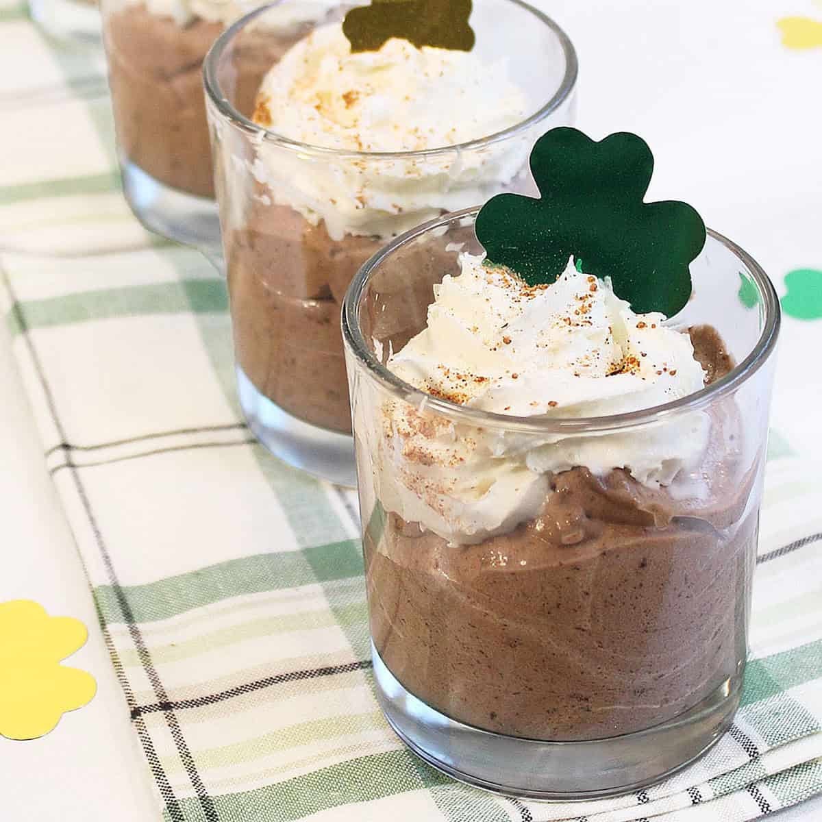 Irish Coffee Mousse with shamrock on green checkered towel.
