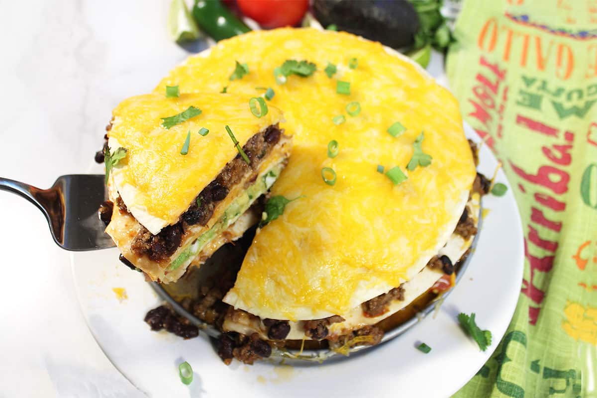 Serving a slice of taco stack.