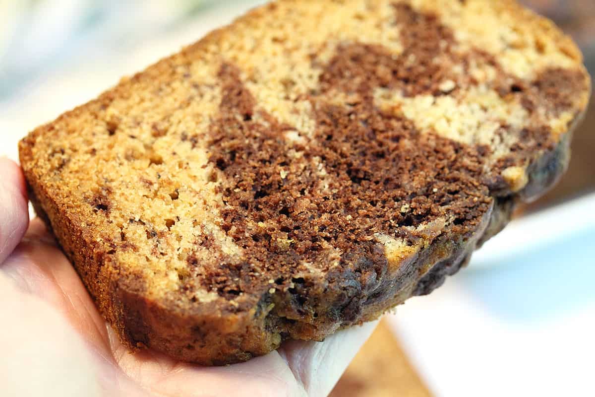 Holding slice of bread closeup to see moistness.