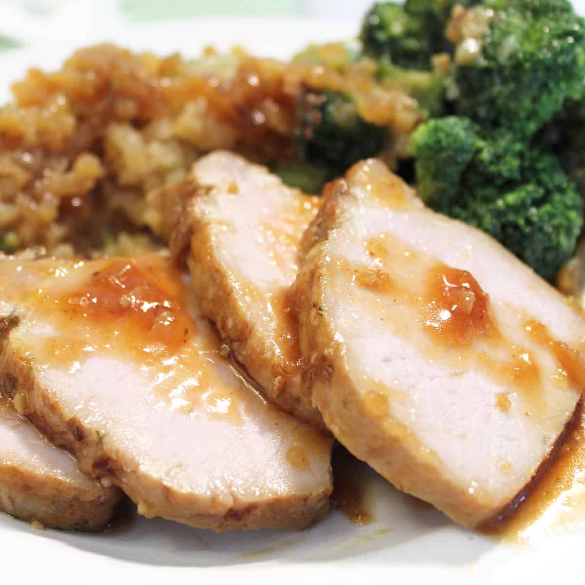 Honey Garlic Tenderloin dinner plated with broccoli and rice.