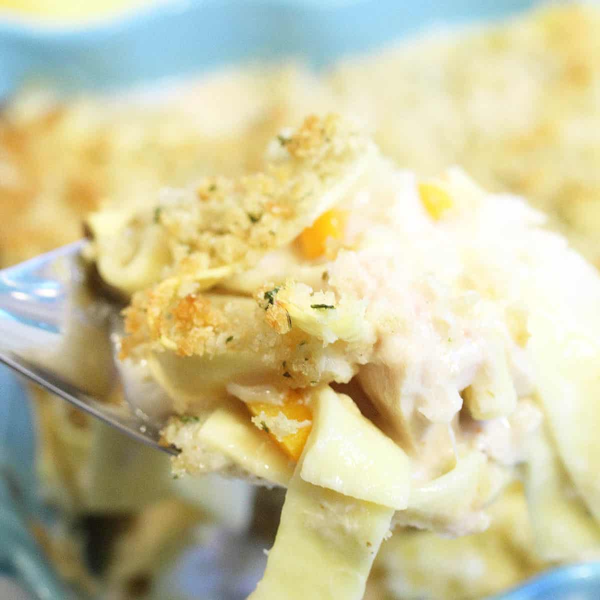 Scooping out serving from casserole dish.
