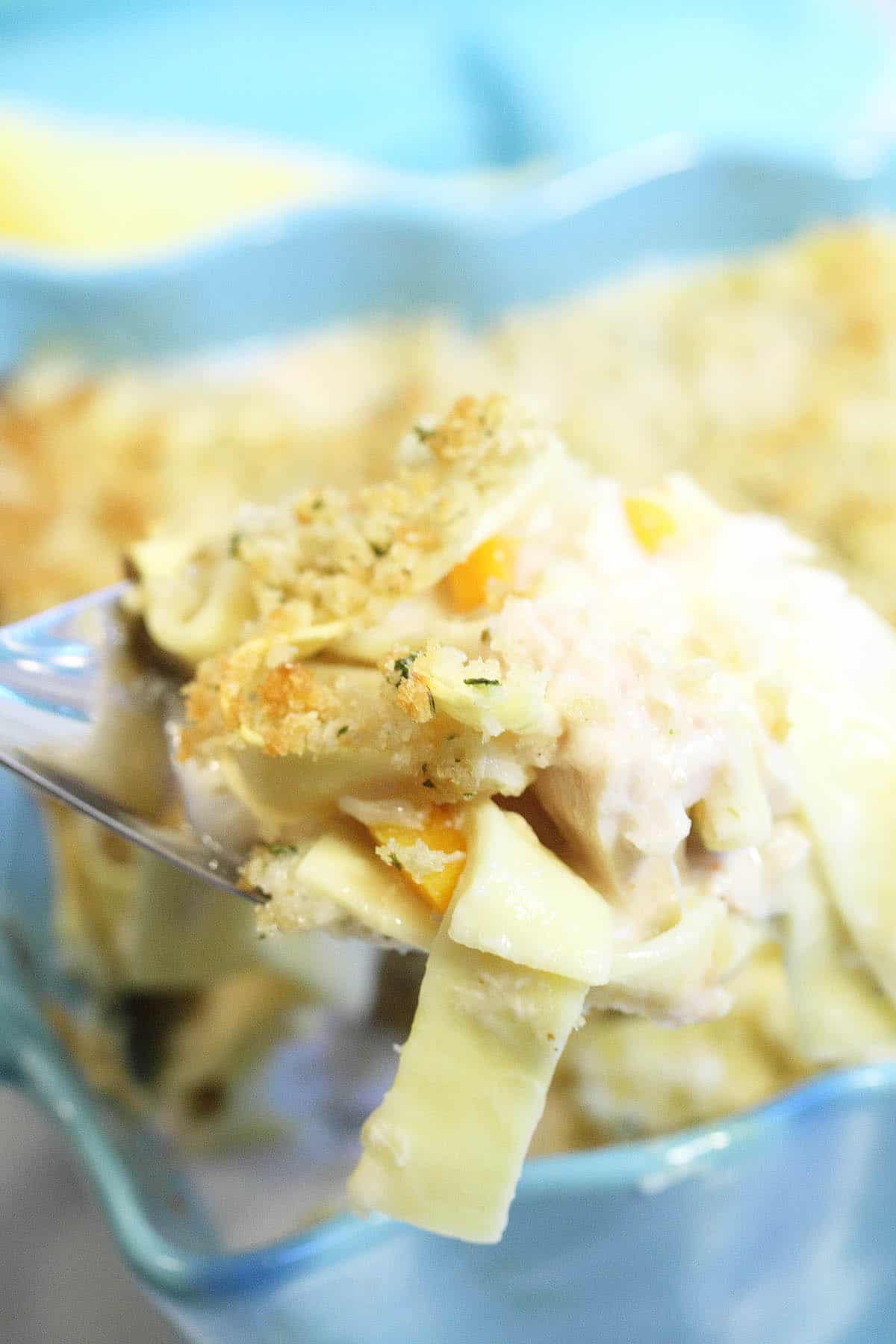 Scooping out serving from casserole dish.