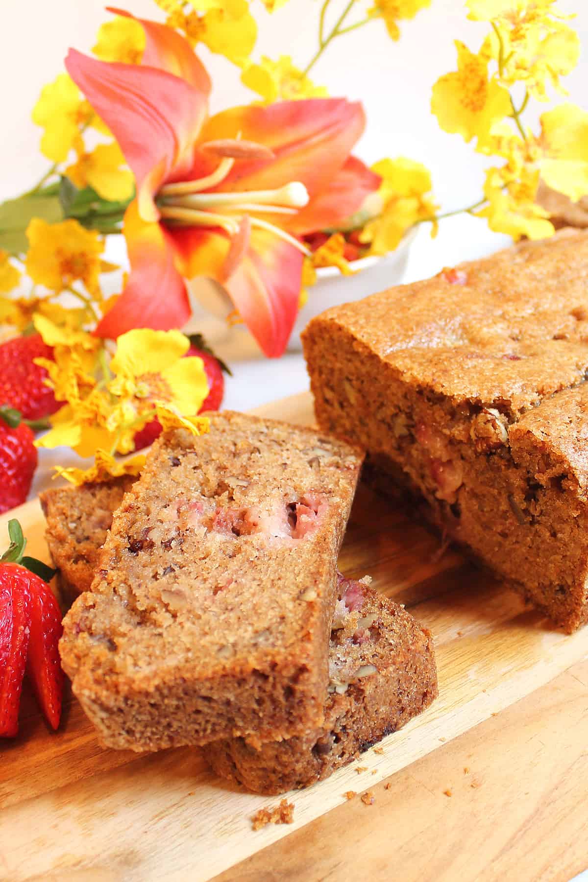 Slices of Fresh Strawberry Bread on wooden board.