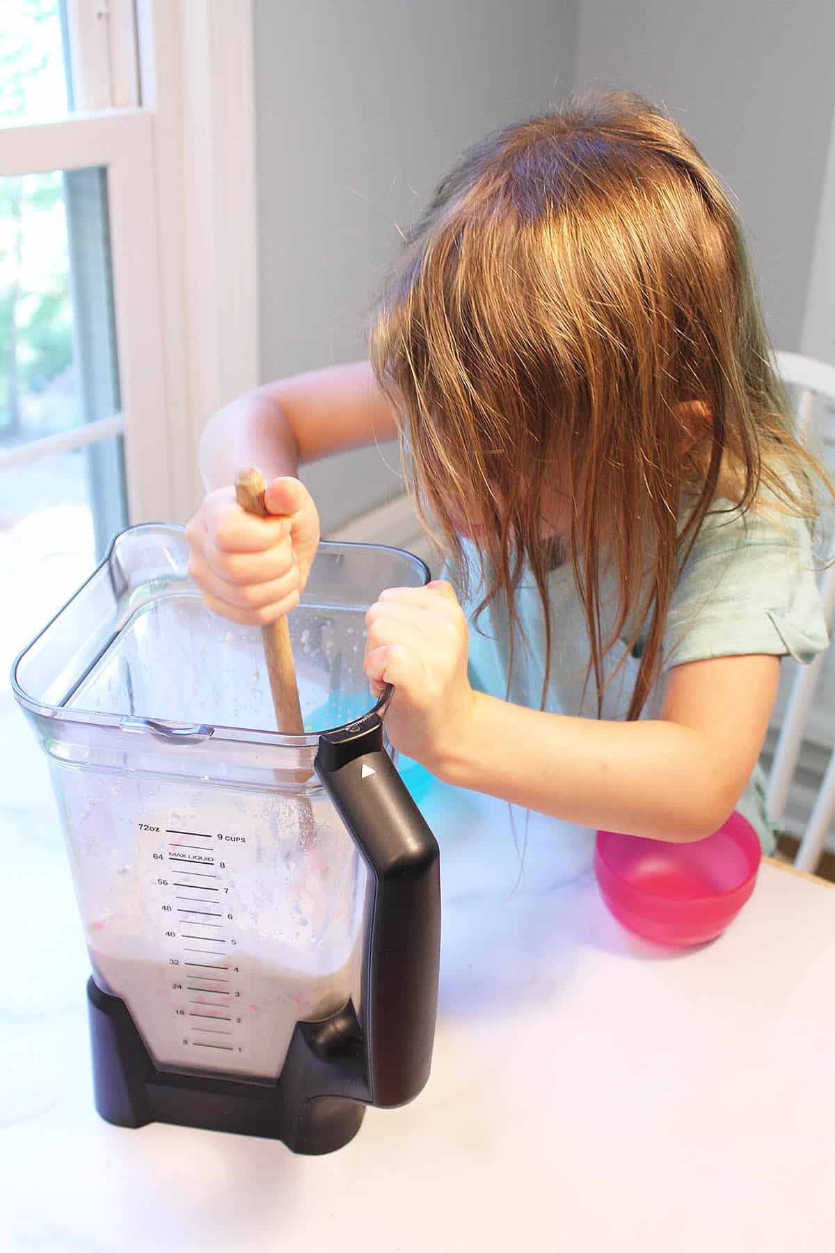 Ana stirring in the sprinkles.