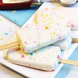 Plateful of popsicles on white plate.