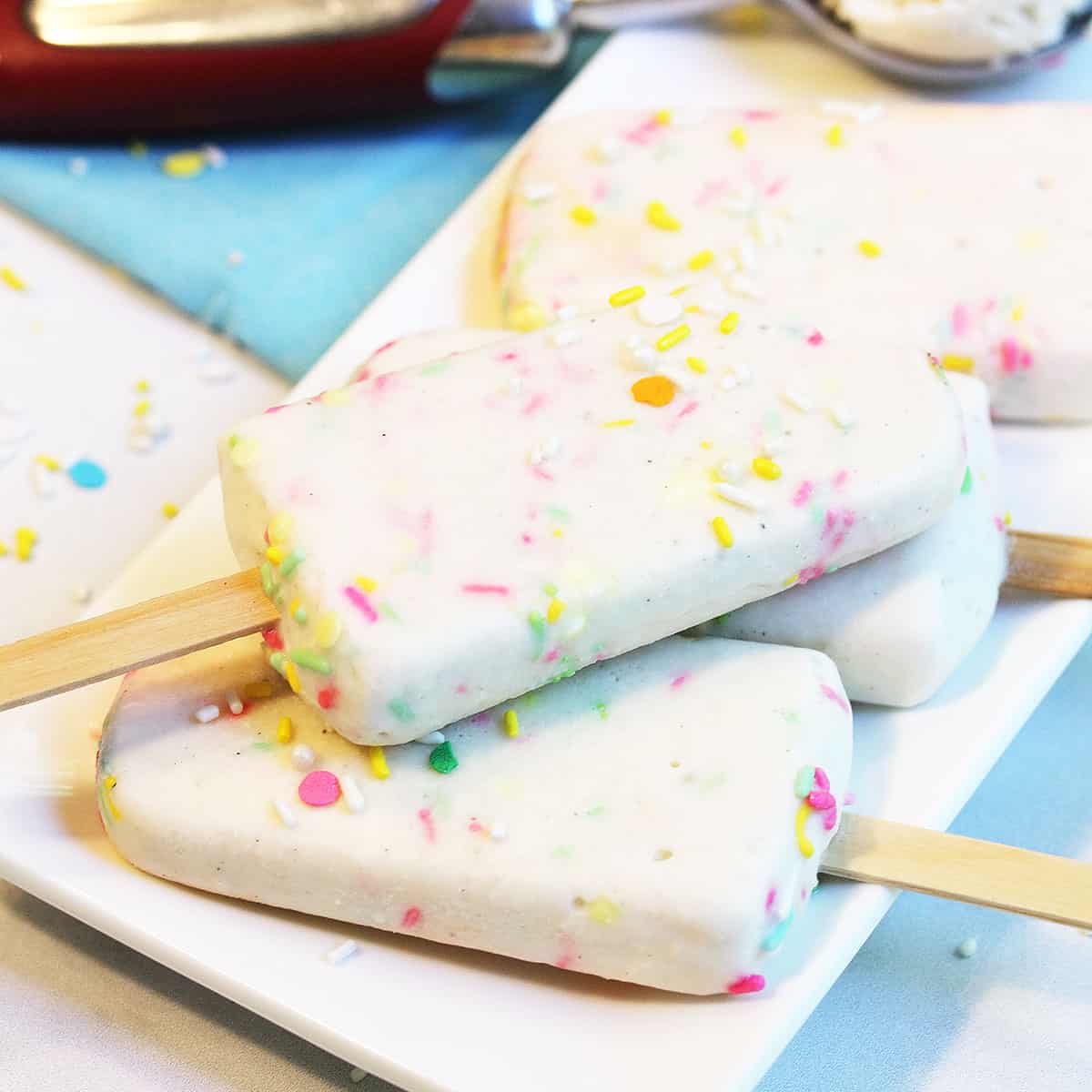 Plateful of popsicles on white plate.
