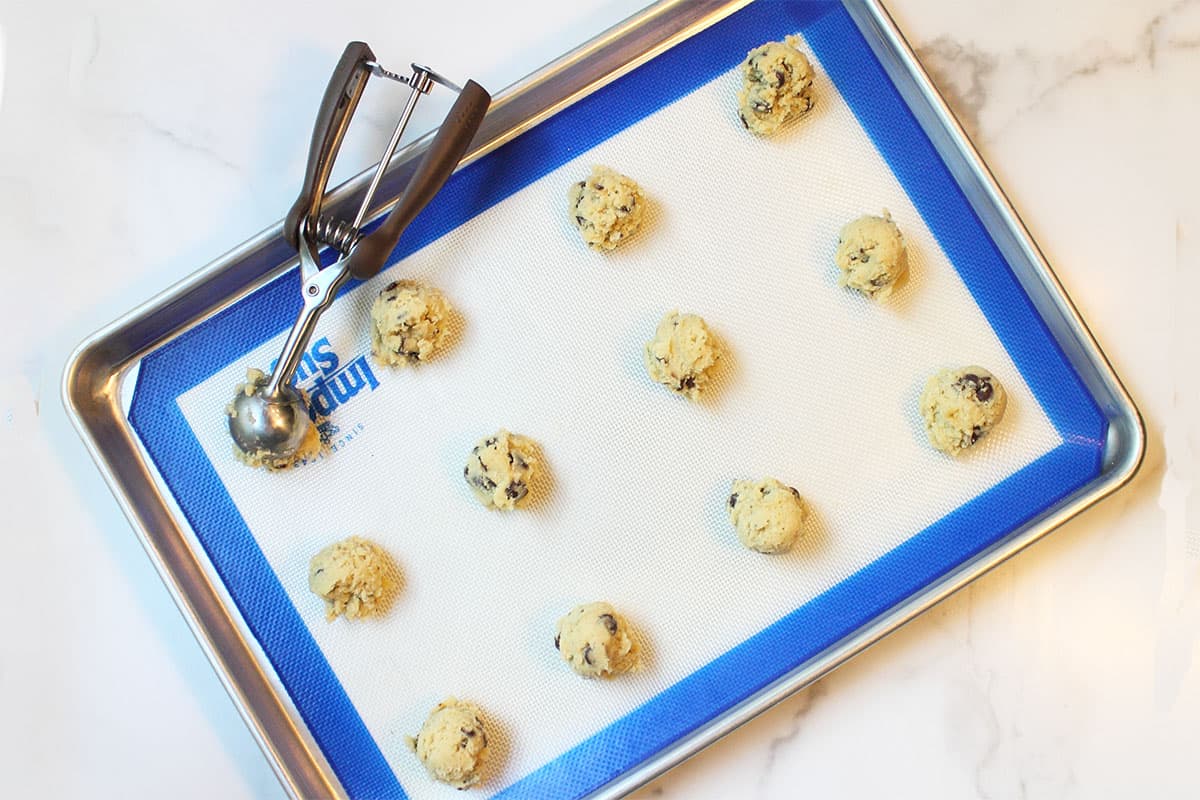 Scooping cookie dough onto cookie sheet.