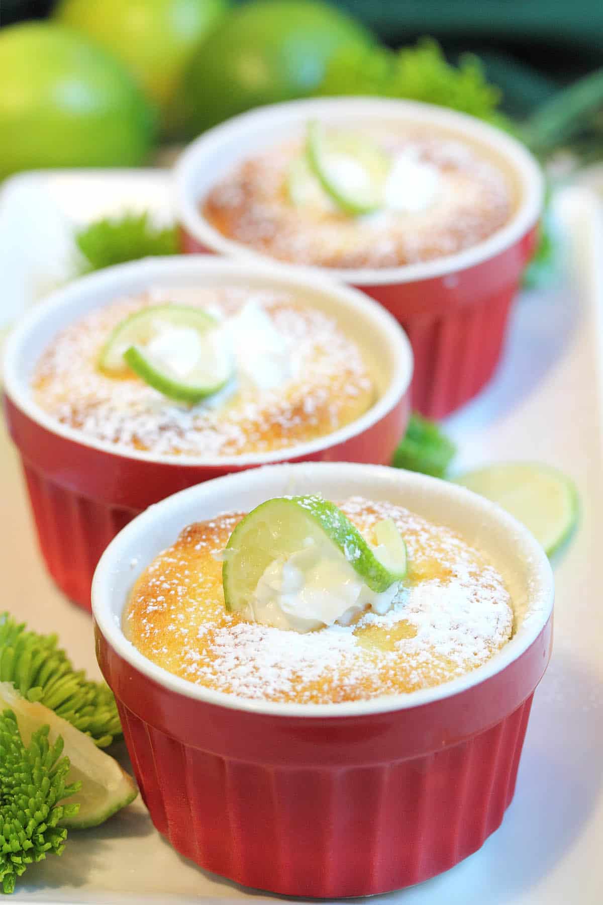 3 ramekins of Key Lime Pudding Cake on platter.