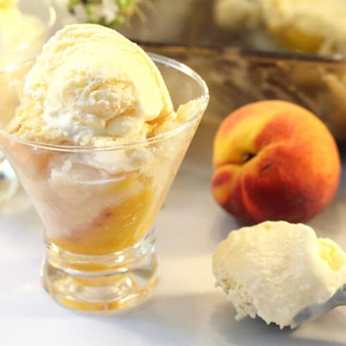Easy Peach Cobbler in serving dish with scoop of ice cream.