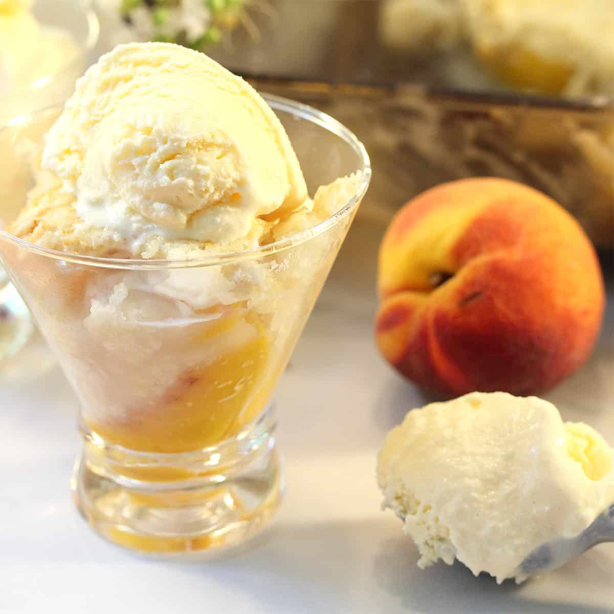 Easy Peach Cobbler in serving dish with scoop of ice cream.
