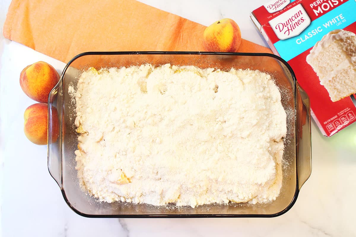 Step 2 Sprinkling cake mix over peaches.